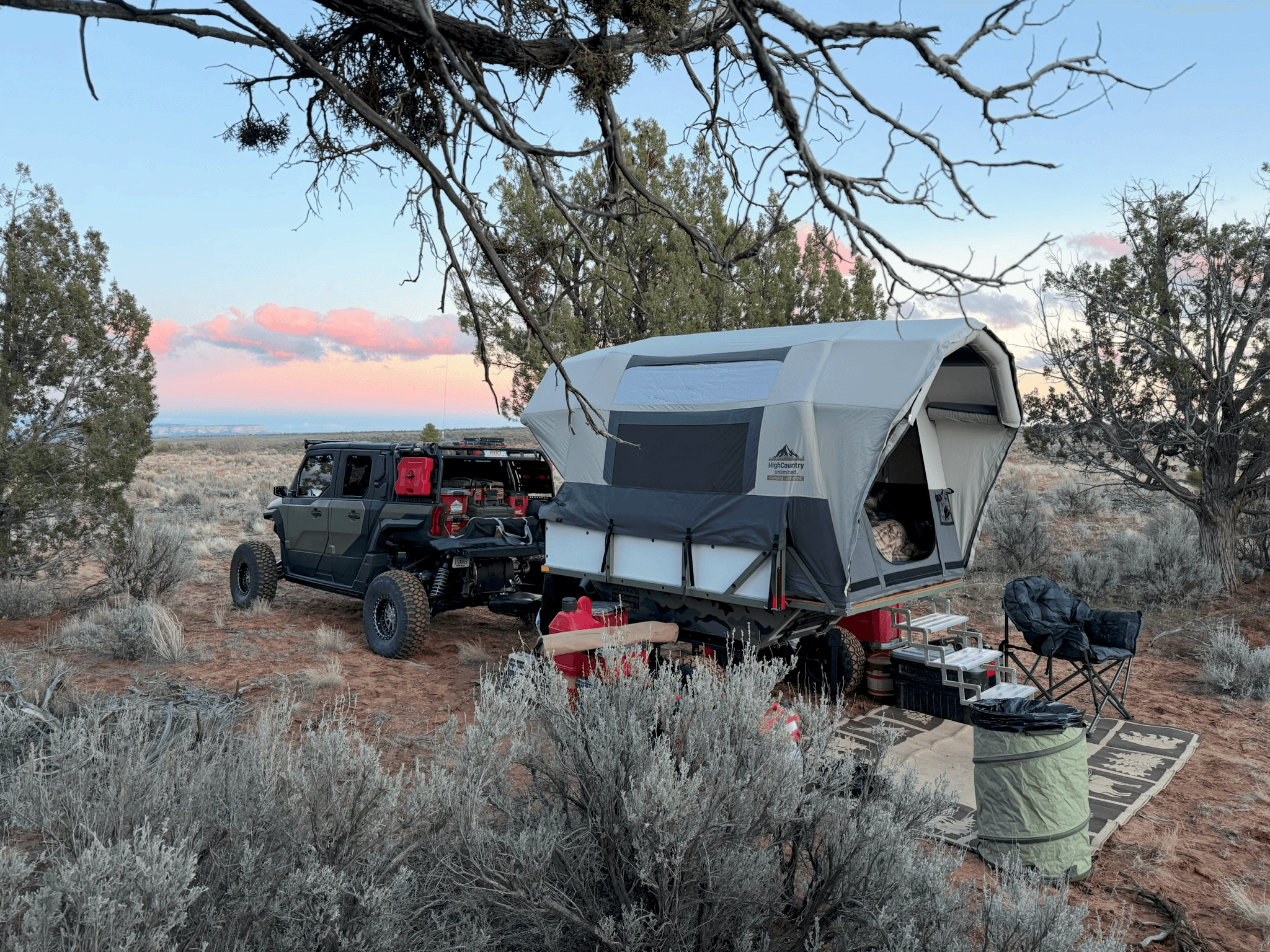 HighCountry Unlimited trailer paired with a UTV at a high-desert camp at dusk