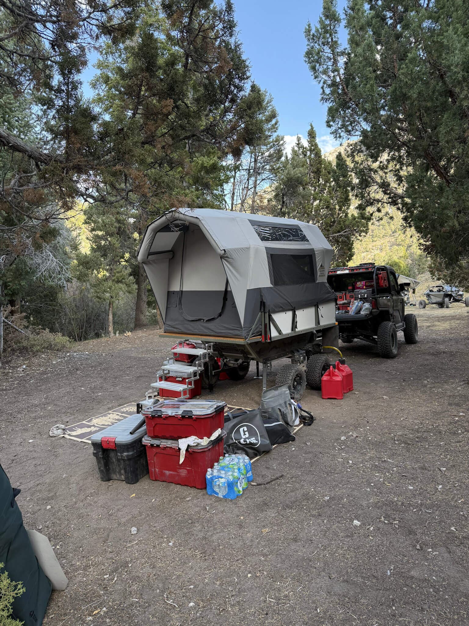 Conestoga Camper with a Polaris RZR pulled in at camp