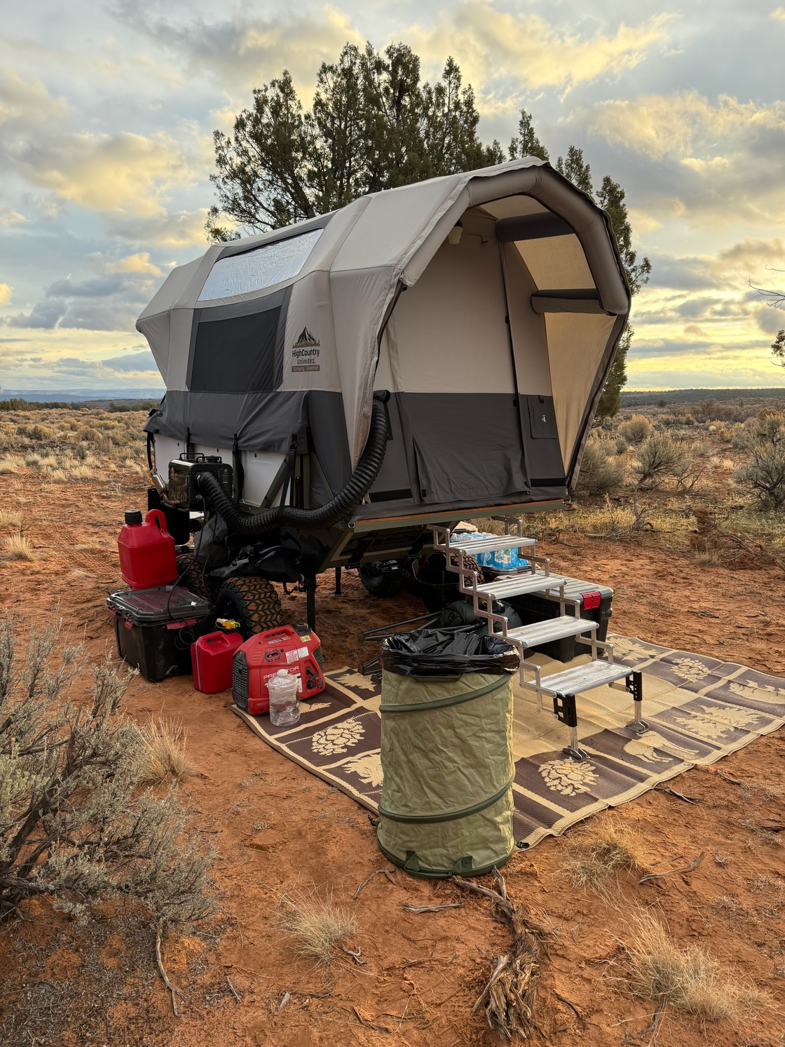 Conestoga Camper set up at a high-desert camp at sunset with airframe tent deployed