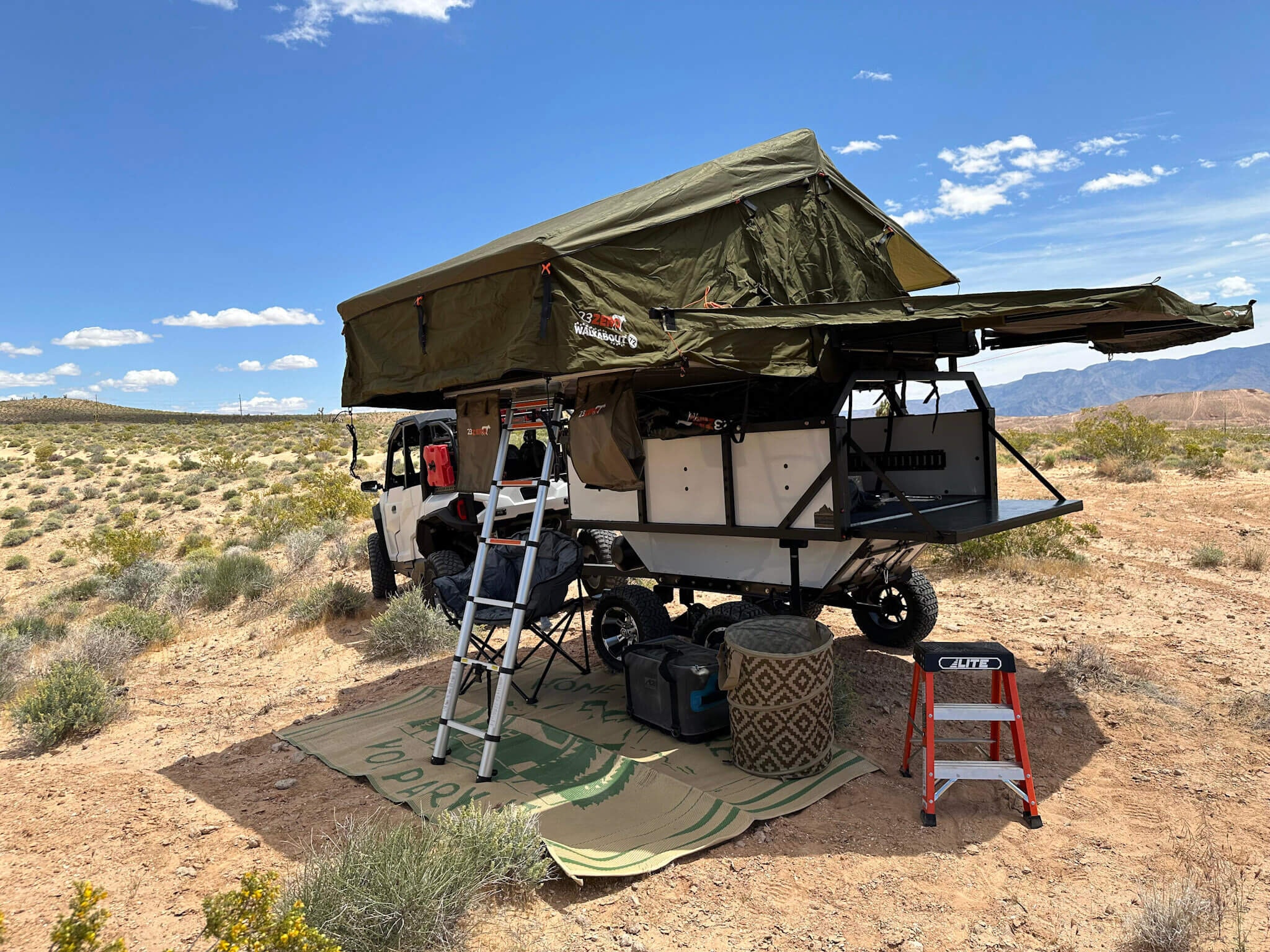 Camp Mansion trailer with 23Zero soft-shell rooftop tent and ladder